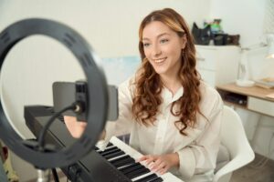 Vlogger preparing to live-stream her music lesson for online audience